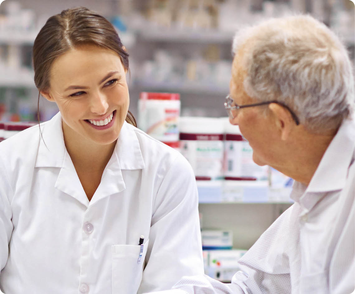 Shot of a young pharmacist helping an elderly customer at the prescription counter