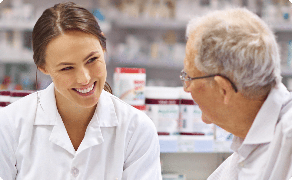 Shot of a young pharmacist helping an elderly customer at the prescription counter