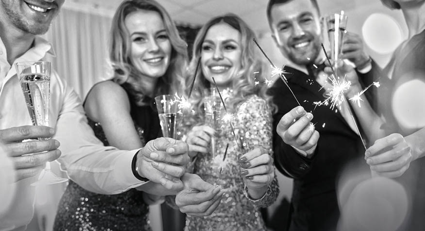 Talking and having fun  Group of people have a new year party indoors together 